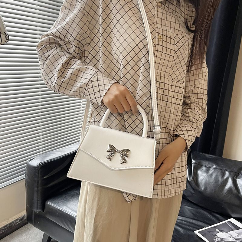 Bow style shoulder handbag