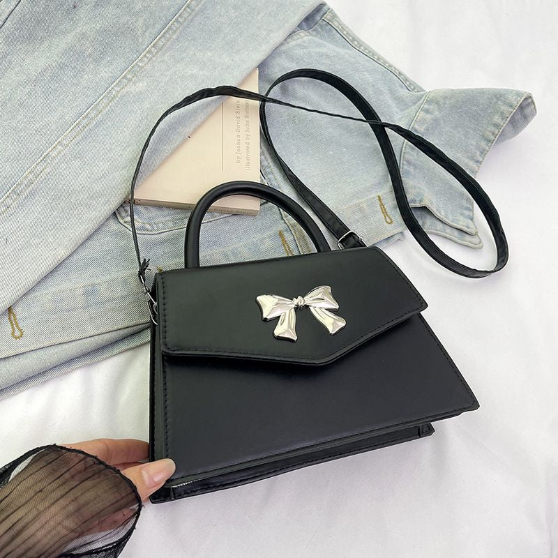Bow style shoulder handbag